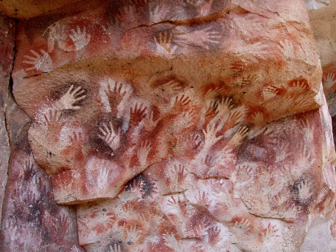 Hands at the Cuevas de las Manos upon Río Pinturas, near the town of Perito Moreno in Santa Cruz Province, Argentina. The art in the cave dates between 13,000–9,000 BP. https://commons.wikimedia.org/wiki/File:SantaCruz-CuevaManos-P2210651b.jpg
